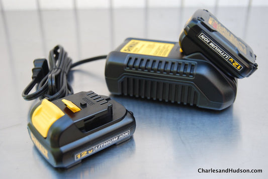 DeWalt 12V lithium-ion battery pack and charger on a metal surface
